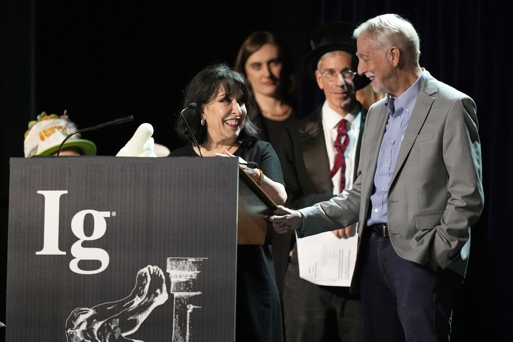 The Ig Nobel Prize for pediatrics is accepted by Julie Mennella and Gary Beauchamp, for studying what a nursing baby experiences when the baby's mother eats garlic, Thursday, Sept. 18, 2025, in Boston. (AP Photo/Robert F. Bukaty)