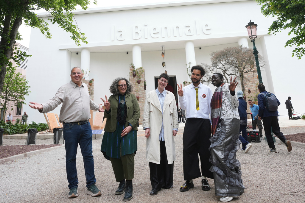 From left, Venice Biennale Art curators, Siddhartha Mitter, Rasha Salti Gabe Beckhurst Feijoo, Rory Tsapayi, and Marie Helene Pereira pose in front of the main entrance at the Venice 2026 Biennale Art, in Venice, Italy, Tuesday, May 5, 2026. (AP Photo/Luca Bruno)