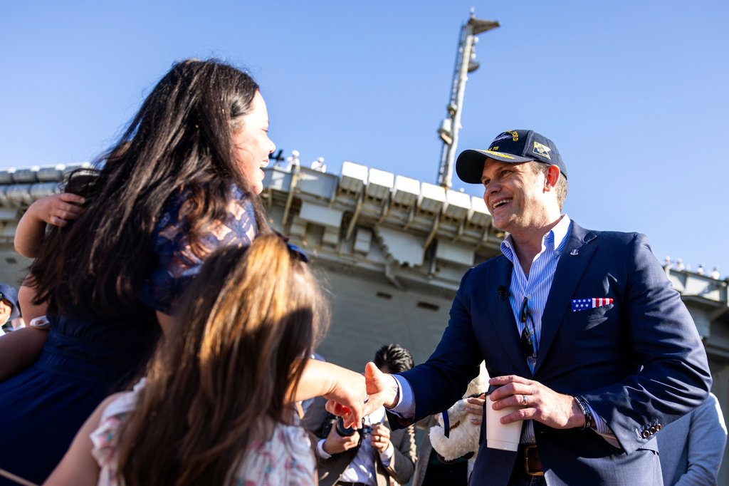 Secretary of Defense Pete Hegseth interacts with Navy families before sailors disembark from the USS Gerald R. Ford at Naval Station Norfolk in Norfolk, Va. on Saturday, May 16, 2026, following an 11 month deployment. (Kendall Warner/The Virginian-Pilot via AP)