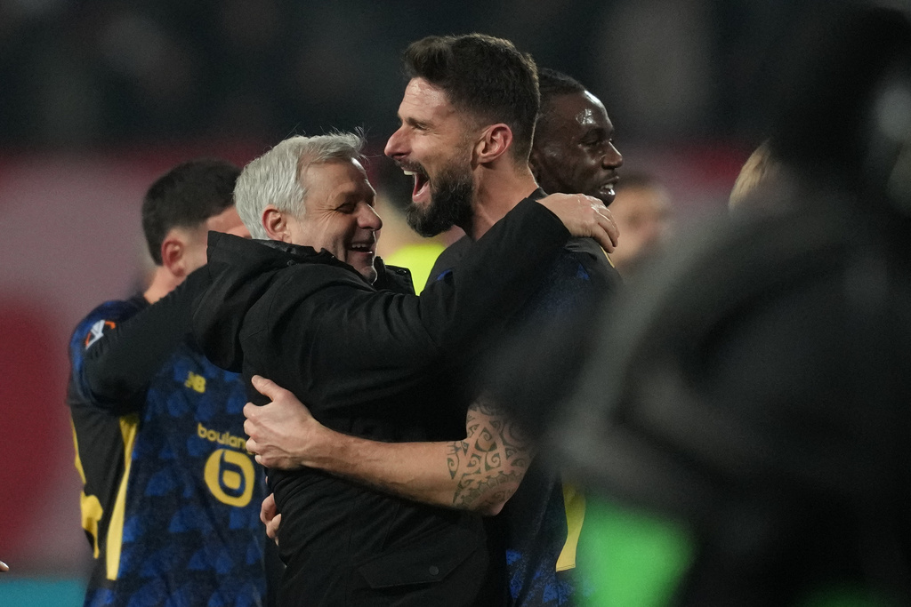 Lille's head coach Bruno Genesio and Olivier Giroud hug after the second leg of the Europa League playoff soccer match between Red Star and Lille in Belgrade, Serbia, Thursday, Feb. 26, 2026. (AP Photo/Darko Vojinovic)