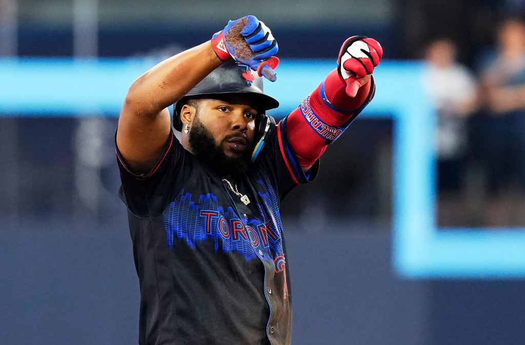Toronto Blue Jays' Vladimir Guerrero Jr. (27) celebrates after hitting a double against the St. Louis Cardinals during sixth inning of a baseball game against the St. Louis Cardinals in Toronto, Friday, July 31, 2026. (Chris Young/The Canadian Press via AP)