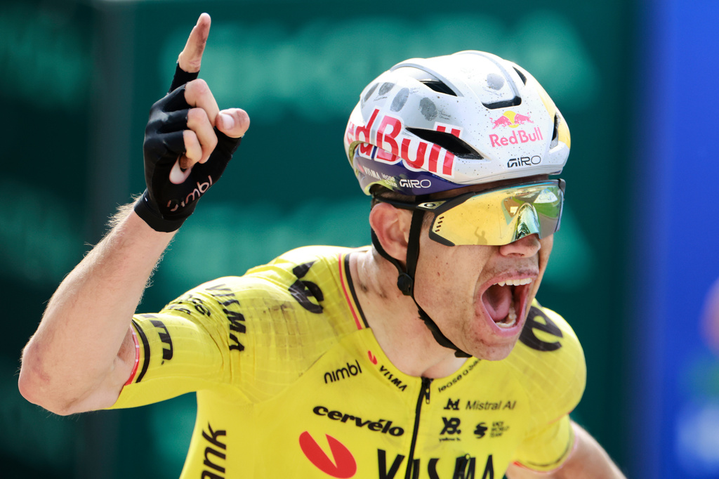 Belgium's Wout van Aert crosses the finish line to win the Paris-Roubaix cycling race in Roubaix, France, Sunday, April 12, 2026. (AP Photo/Jean-Francois Badias)