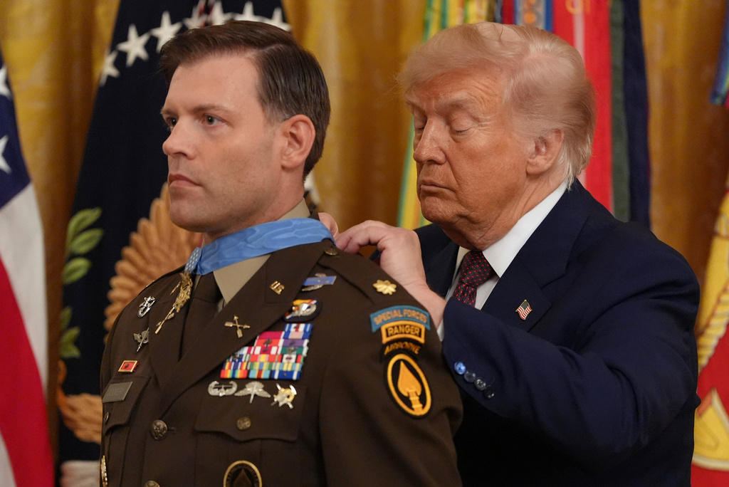 President Donald Trump, right, awards the Medal of Honor to retired Army Maj. Nicholas Dockery, in the East Room of the White House, Thursday, June 18, 2026, in Washington. (AP Photo/Jacquelyn Martin)