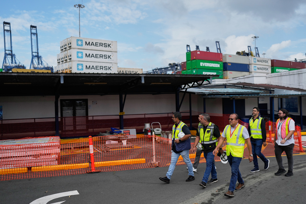 Workers walk at the Balboa terminal, run by CK Hutchison's Panama Ports Co., after Panama government ordered the occupation of the port following a Supreme Court ruling that the concession was unconstitutional inPanama City, Panama, Monday, Feb. 23, 2026. (AP Photo/Matias Delacroix)