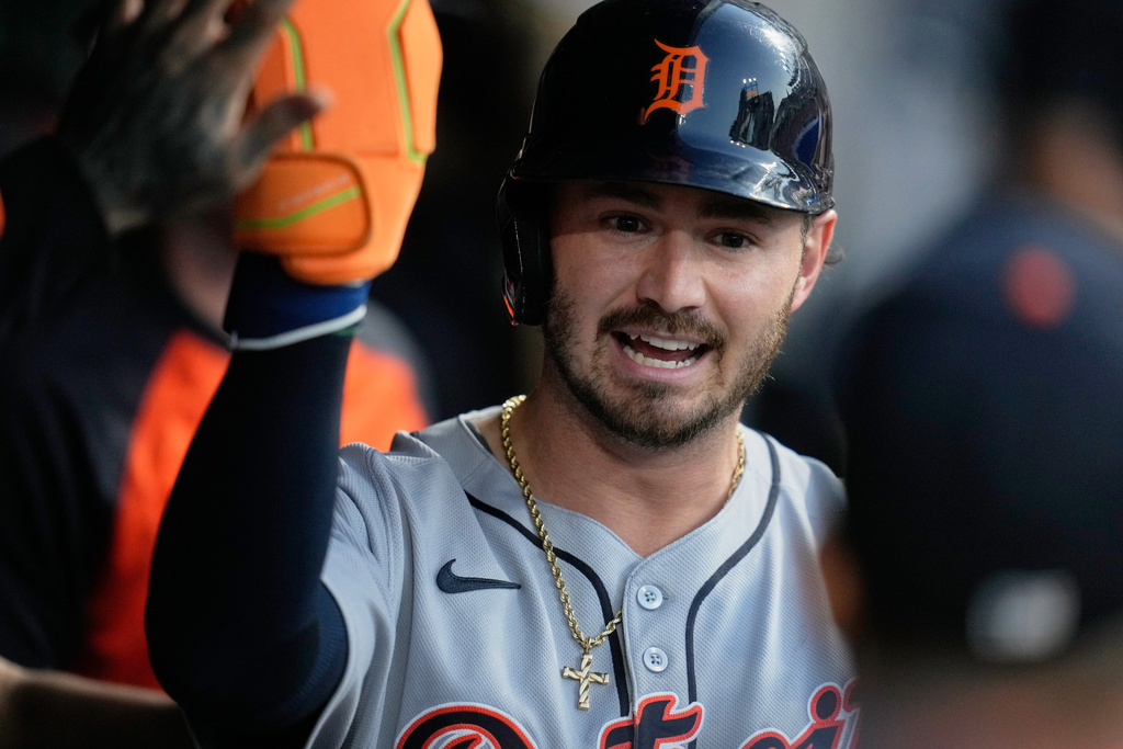 Detroit Tigers' Zach McKinstry is congratulated in the dugout after scoring in the third inning of a baseball game against the Cleveland Guardians in Cleveland, Tuesday, Sept. 23, 2025. (AP Photo/Sue Ogrocki)