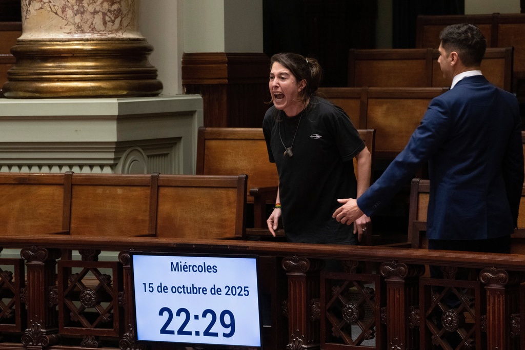 A woman shouts, "Murderers" in Spanish after Uruguay's senate passed a law decriminalizing euthanasia, in Montevideo, Uruguay, Wednesday, Oct. 15, 2025. (AP Photo/Matilde Campodonico)