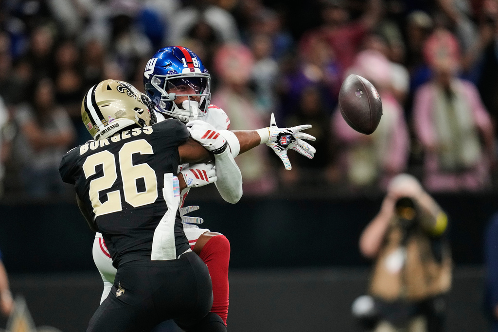 New Orleans Saints safety Terrell Burgess (26) breaks up a pass intended for New York Giants wide receiver Darius Slayton in the first half of an NFL football game in New Orleans, Sunday, Oct. 5, 2025. (AP Photo/Gerald Herbert)