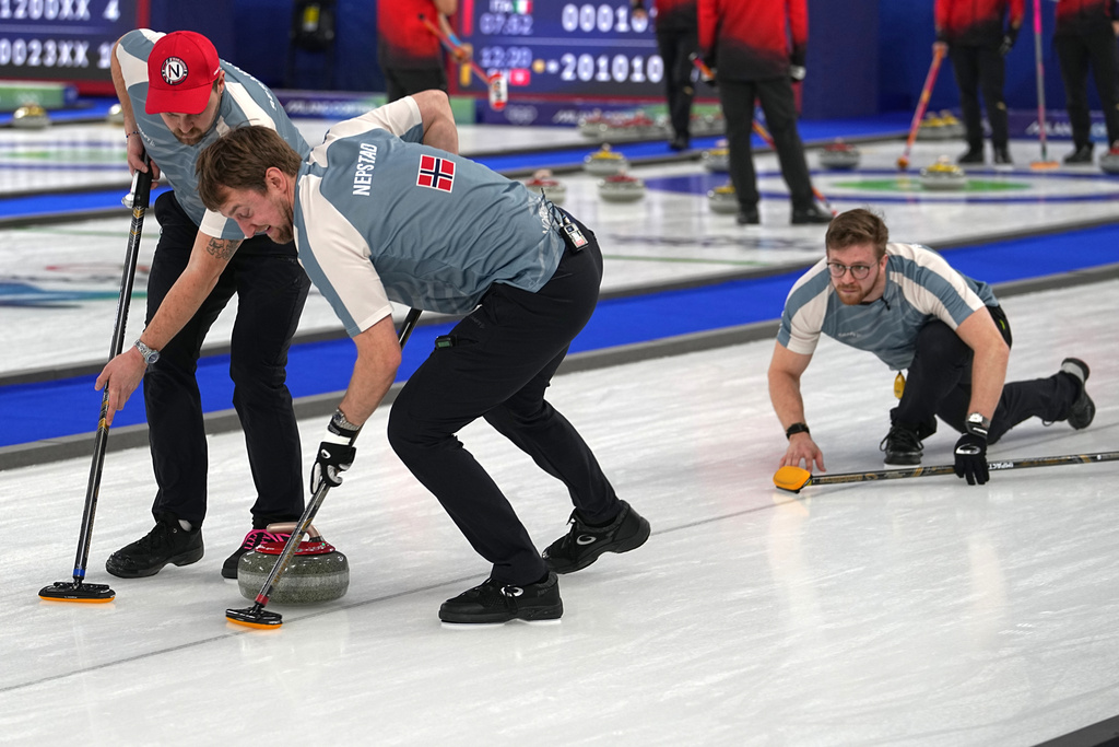 Norway's Martin Sesaker, Bendik Ramsfjell and Gaute Nepstad in action during the men's curling round robin session against Canada at the 2026 Winter Olympics, in Cortina d'Ampezzo, Italy, Thursday, Feb. 19, 2026. (AP Photo/Fatima Shbair)