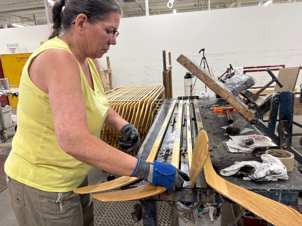 A worker makes wooden hockey sticks at the Roustan Hockey factory, which is the last major manufacturer of hockey sticks in Canada on Aug. 27, 2025 in Brantford, Ontario. (AP Photo/Kelvin Chan)