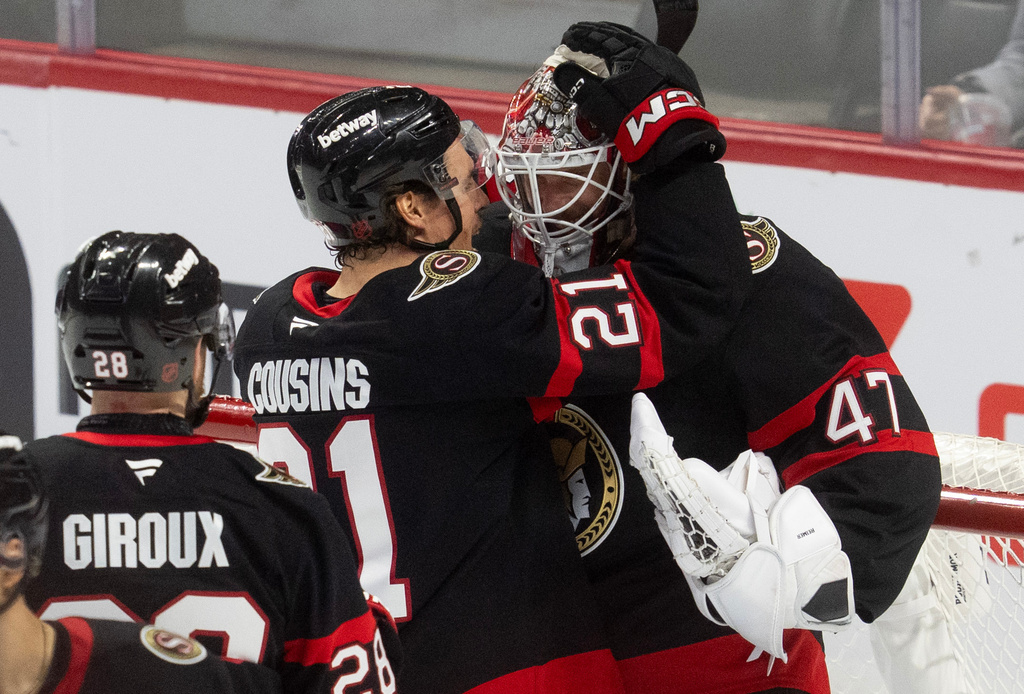 Ottawa Senators' Nick Cousins (21) congratulates goaltender James Reimer (47) as Claude Giroux (28) looks on after defeating the New York Islanders in an NHL hockey game in Ottawa, Ontario, Thursday, March 19, 2026. (Adrian Wyld/The Canadian Press via AP)