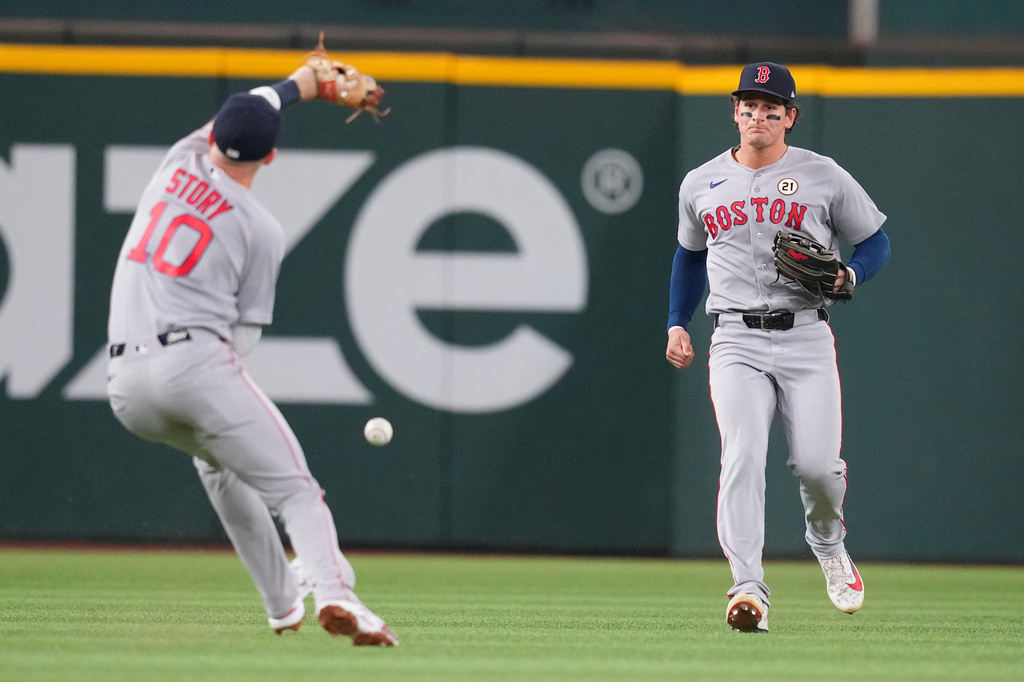 Boston Red Sox left fielder Roman Anthony, right, watches as teammate shortstop Trevor Story (10) is unable to catch a two-run single by Texas Rangers' Corey Seager, not visible, during the second inning of a baseball game Tuesday, Sept. 15, 2026, in Arlington, Texas. (AP Photo/Julio Cortez)