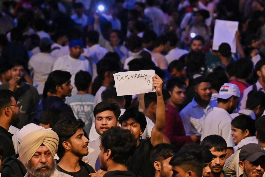A protestor holds a piece of paper with "Democracy?" written on it during a demonstration demanding educational reforms as part of the Cockroach Janta Party's ongoing protest movement in New Delhi, India, Wednesday, July 22, 2026. (AP Photo/Vipin)