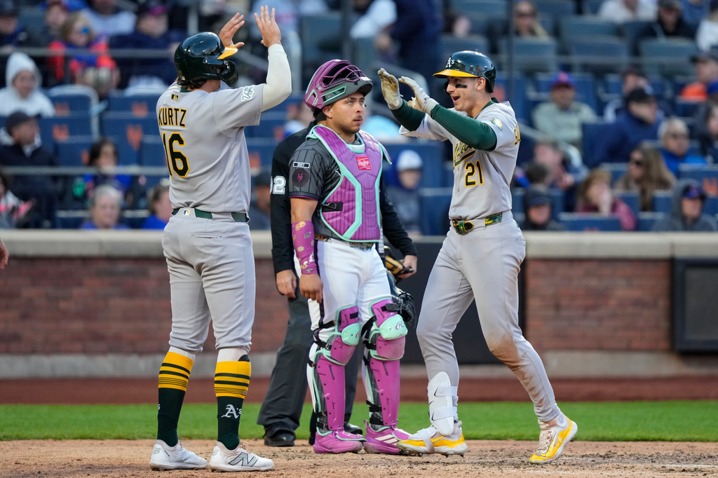 Athletics' Tyler Soderstrom (21) celebrates with Nick Kurtz (16) after hitting a three-run home run during the eighth inning of a baseball game against the New York Mets, Saturday, April 11, 2026, in New York. (AP Photo/Yuki Iwamura)