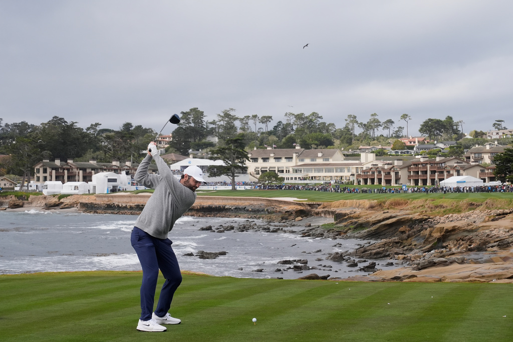 Scottie Scheffler hits from the 18th tee at Pebble Beach Golf Links during the final round of the AT&T Pebble Beach Pro-Am golf tournament in Pebble Beach, Calif., Sunday, Feb. 15, 2026. (AP Photo/Godofredo A. Vásquez)