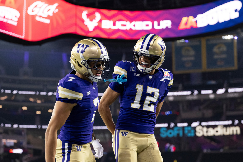 Washington wide receiver Raiden Vines-Bright (7) and wide receiver Denzel Boston (12) celebrate after a touchdown by Vines-Bright during the LA Bowl NCAA college football game against Boise State, Saturday, Dec. 13, 2025, in Inglewood, Calif. (AP Photo/Kyusung Gong)