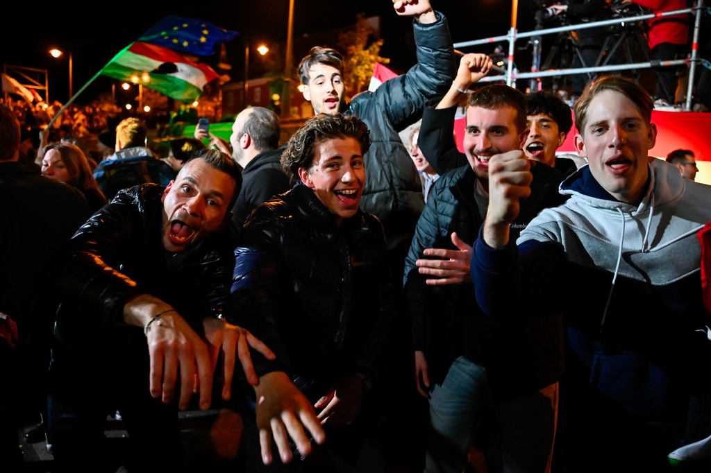 People celebrate in the streets following the announcement of the partial results of the parliamentary election, in Budapest, Hungary, Sunday, April 12, 2026. (AP Photo/Denes Erdos)