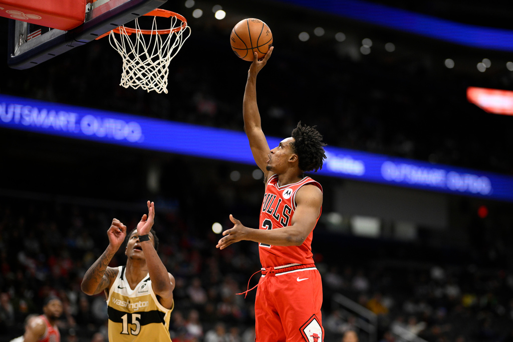 Chicago Bulls guard Collin Sexton, right, shoots against Washington Wizards forward Juju Reese (15) during the first half of an NBA basketball game, Thursday, April 9, 2026, in Washington. (AP Photo/Nick Wass)