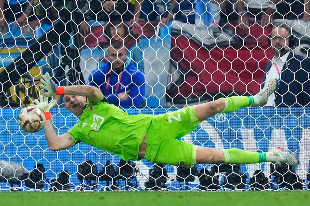 FILE - Argentina's goalkeeper Emiliano Martinez blocks a shot by France's Kingsley Coman during a penalty shootout in the World Cup final soccer match between Argentina and France at the Lusail Stadium in Lusail, Qatar, Sunday, Dec. 18, 2022. (AP Photo/Natacha Pisarenko, File)