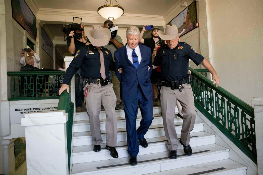 Texas megachurch founder Robert Morris is escorted out of the building after pleading guilty to lewd and indecent acts with a child at the Osage County Courthouse in Pawhuska, Okla., on Thursday, Oct. 2, 2025. (Juan Figueroa/The Dallas Morning News via AP)