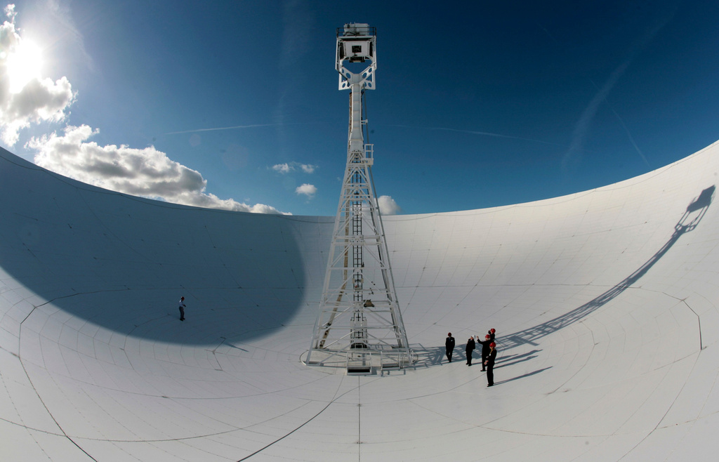 FILE - Members of a conference to mark the 50th anniversary of space travel stand in the dish of the The Lovell Telescope at Jodrell Bank Observatory, Macclesfield, England Thursday Oct. 4, 2007. (AP Photo/Jon Super, file)