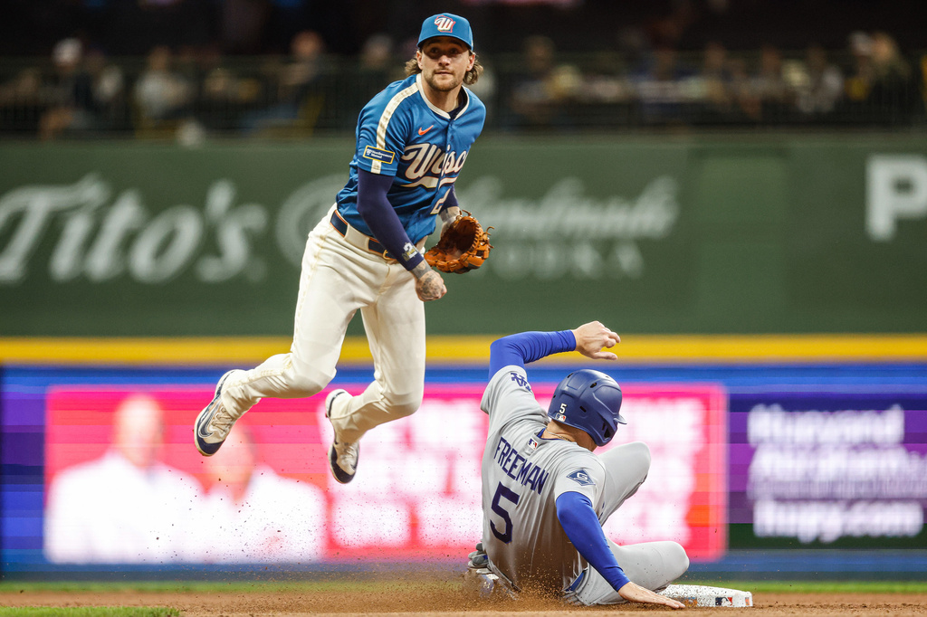 Milwaukee Brewers second baseman Brice Turang (2) forces out Los Angeles Dodgers' Freddie Freeman during the seventh inning of a baseball game, Friday, May 22, 2026, in Milwaukee. (AP Photo/Jeffrey Phelps)