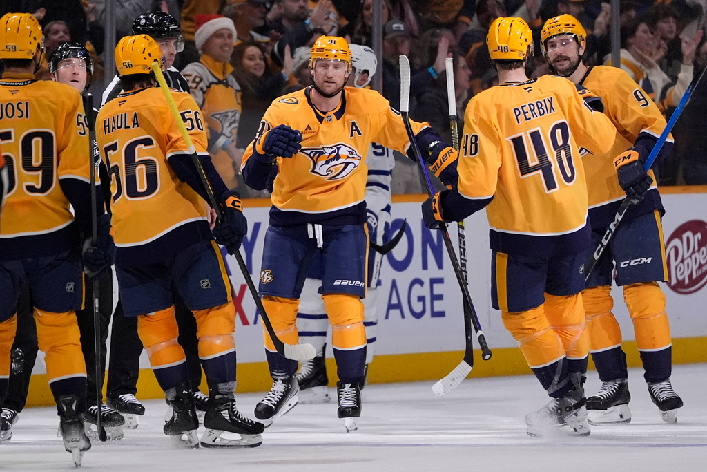 Nashville Predators center Steven Stamkos (91) celebrates his empty net goal with teammates during the third period of an NHL hockey game against the Toronto Maple Leafs, Saturday, Dec. 20, 2025, in Nashville, Tenn. (AP Photo/George Walker IV)