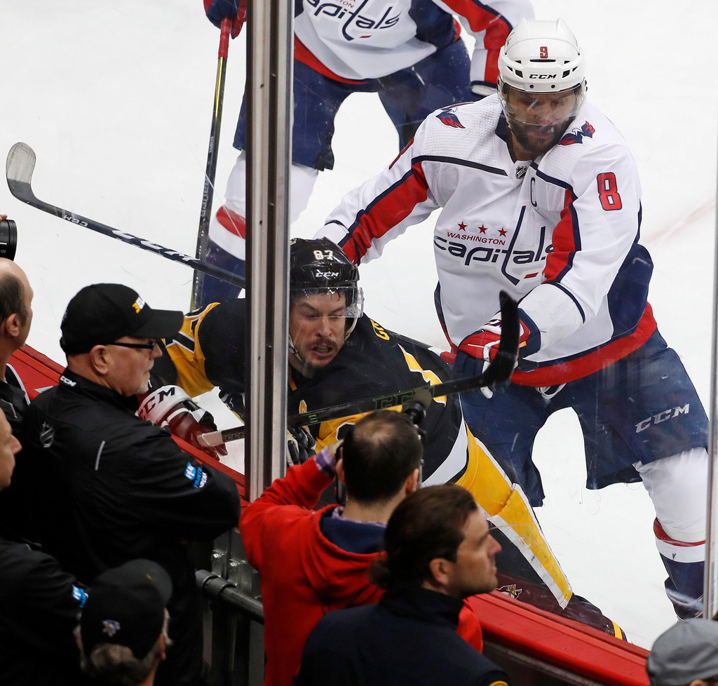 FILE - Washington Capitals' Alex Ovechkin (8) cross checks Pittsburgh Penguins' Sidney Crosby (87) during the second period in Game 3 of an NHL second-round hockey playoff series in Pittsburgh, Tuesday, May 1, 2018. (AP Photo/Gene J. Puskar, File)