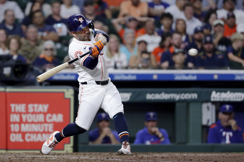 Houston Astros' Jose Altuve swings on his two run home run against the Texas Rangers during the third inning of a baseball game Wednesday, Sept. 17, 2025, in Houston. (AP Photo/Michael Wyke)