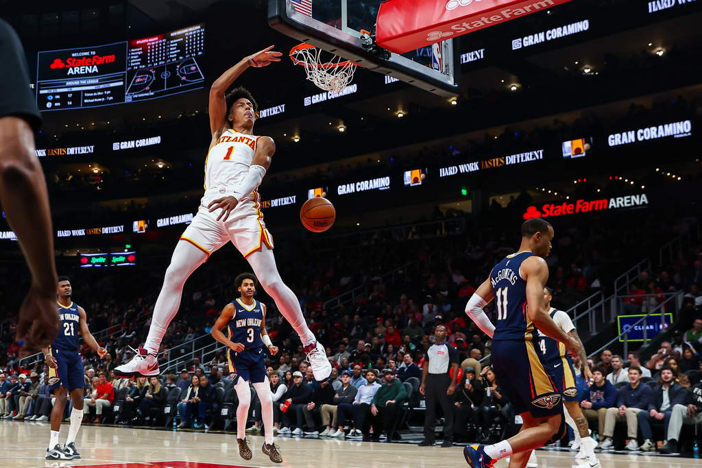 Atlanta Hawks forward Jalen Johnson (1) dunks against New Orleans Pelicans guard Bryce McGowens (11) during the first half of an NBA basketball game, Wednesday, Jan. 7, 2026, in Atlanta. (AP Photo/Colin Hubbard)