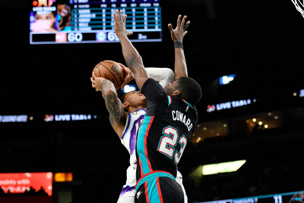Utah Jazz guard Keyonte George, left, shoots against Memphis Grizzlies forward Cedric Coward (23) in the first half of an NBA basketball game Friday, Dec. 12, 2025, in Memphis, Tenn. (AP Photo/Brandon Dill)