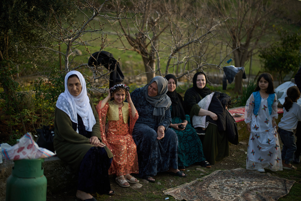 Women take part in a family gathering to break the fast with an Iftar meal during the Muslim holy month of Ramadan in the village of Gulp, Iraq, Tuesday, March 17, 2026. (AP Photo/Leo Correa)