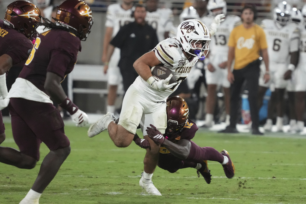 Texas State running back Lincoln Pare runs away from Arizona State defensive back Javan Robinson (12) in the second half of an NCAA college football game, Saturday, Sept. 13, 2025, in Tempe, Ariz. (AP Photo/Rick Scuteri)