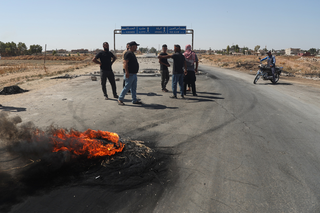 Local residents block a road to prevent oil tankers from the Rmeilan oil fields from passing during ongoing protests against higher fuel prices at the entrance to Tal Tamr, northeastern Syria, Wednesday, Sept. 16, 2026. (AP Photo/Baderkhan Ahmad)