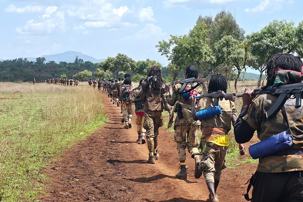 Oromo Liberation Army (OLA) fighters walk single file carrying rifles in Oromia, Ethiopia, June 2, 2025. (AP Photo)