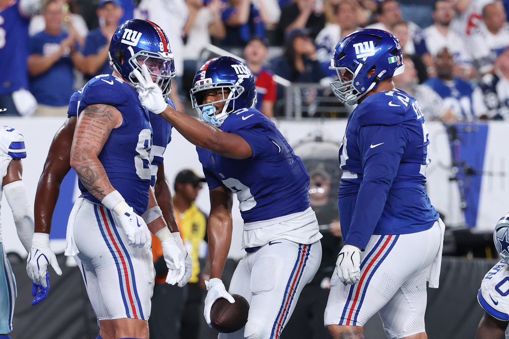 New York Giants tight end Isaiah Likely, center, gestures after scoring a touchdown against the Dallas Cowboys during the second half of an NFL football game Sunday, Sept. 13, 2026, in East Rutherford, N.J. (AP Photo/Pamela Smith)