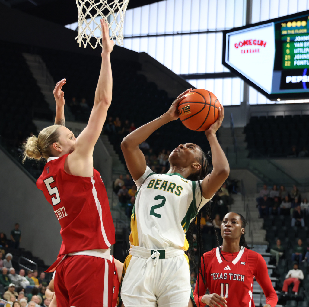 Baylor forward Kiersten Johnson (2) attempts a basket against Texas Tech guard Denae Fritz (5) in the first half of an NCAA college basketball game, Sunday, Dec. 21, 2025, in Waco, Texas. (Rod Aydelotte/Waco Tribune-Herald via AP)