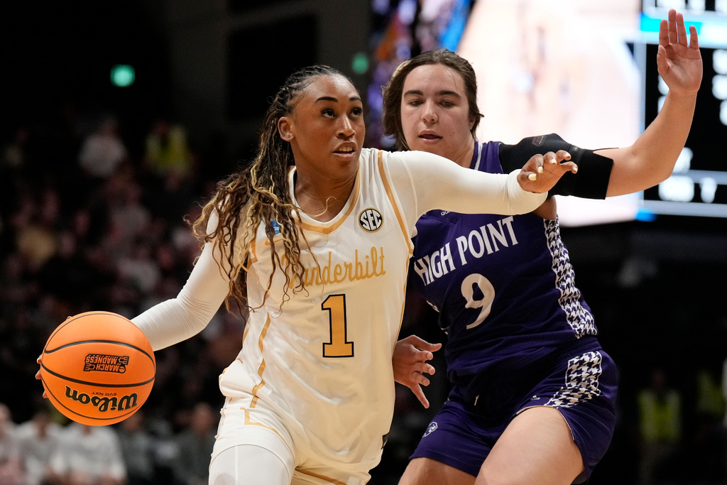 Vanderbilt guard Mikayla Blakes (1) drives the ball past High Point guard Dom Nesland (9) during the first half in the first round of the NCAA college basketball tournament Saturday, March 21, 2026, in Nashville, Tenn. (AP Photo/George Walker IV)