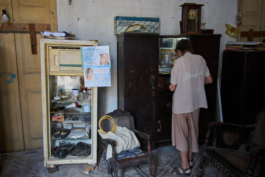 Carmen Casado, 84, looks through her wardrobe at her home in Old Havana, Cuba, Tuesday, April 21, 2026. (AP Photo/Ramon Espinosa)