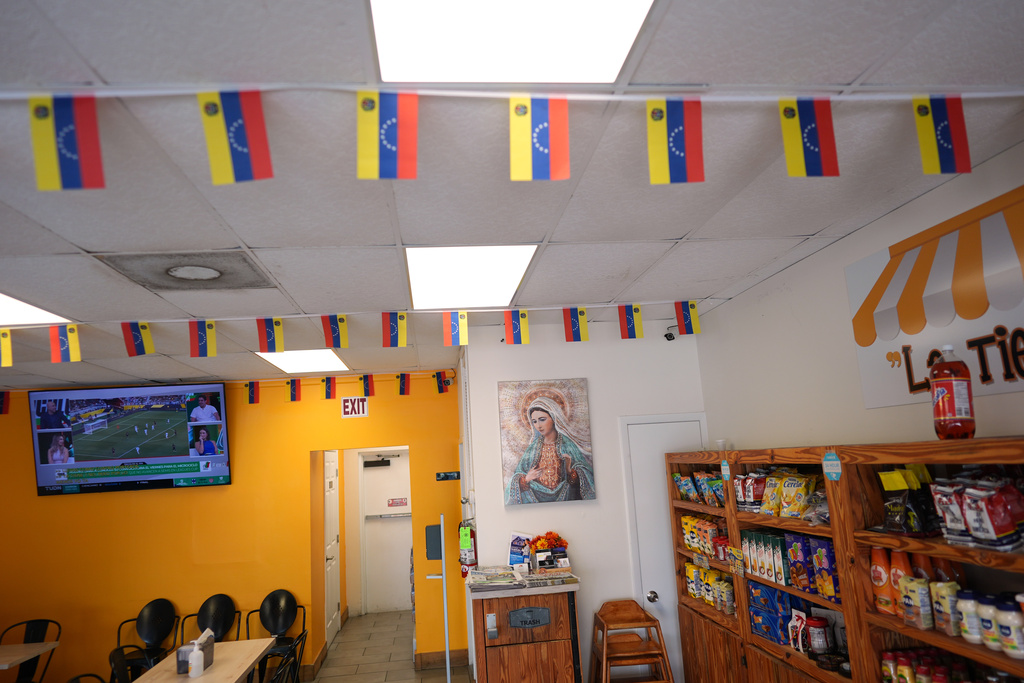 Venezuelan flags hang inside TeqaBite, a restaurant co-owned by two U.S. citizens born in Venezuela, in Kissimmee, Fla., Thursday, Aug. 21, 2025. (AP Photo/Rebecca Blackwell)