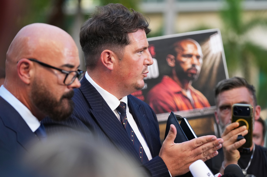 Solicitor Andrew Ford speaks with the news media after a bond hearing for Andrew and Tristan Tate as they fight extradition to the United Kingdom on charges of rape and sex trafficking, left, at the C. Clyde Atkins U.S. Courthouse, Thursday, Aug. 27, 2026, in Miami. (AP Photo/Lynne Sladky)