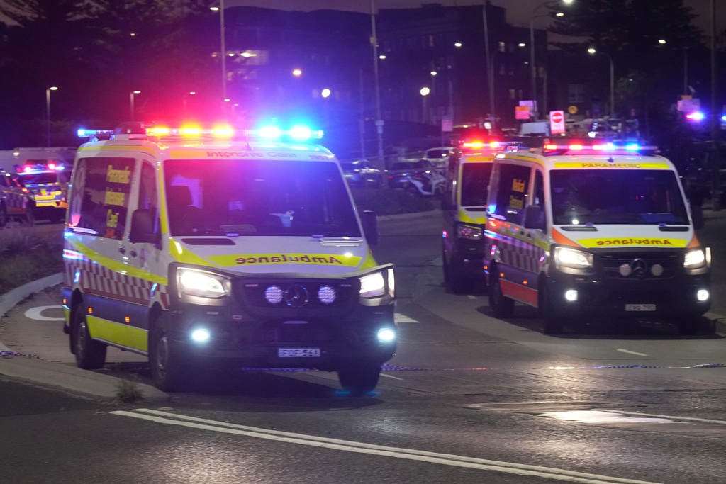Ambulances move around at Bondi Beach after a reported shooting in Sydney, Sunday, Dec. 14, 2025. (AP Photo/Mark Baker)