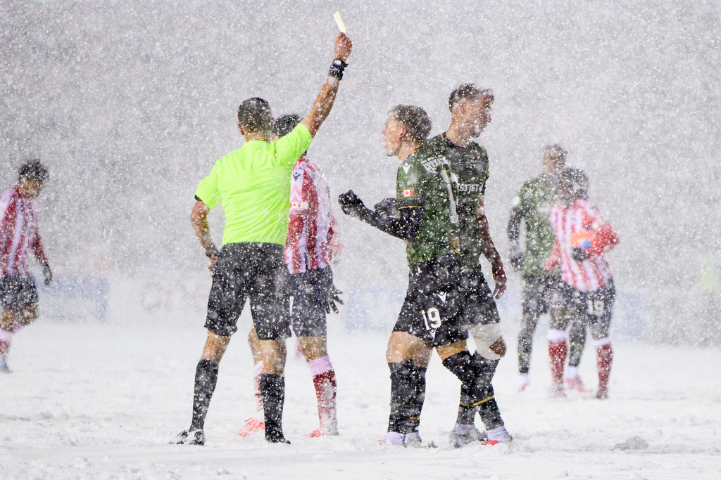 Cavalry FC's Mihail Gherasimencov (19) complains to a referee, center left, after being issued a yellow card during second-half Canadian Premier League finals soccer match action against Atletico Ottawa in Ottawa, Ontario, Sunday, Nov. 9, 2025. (Spencer Colby/The Canadian Press via AP) I