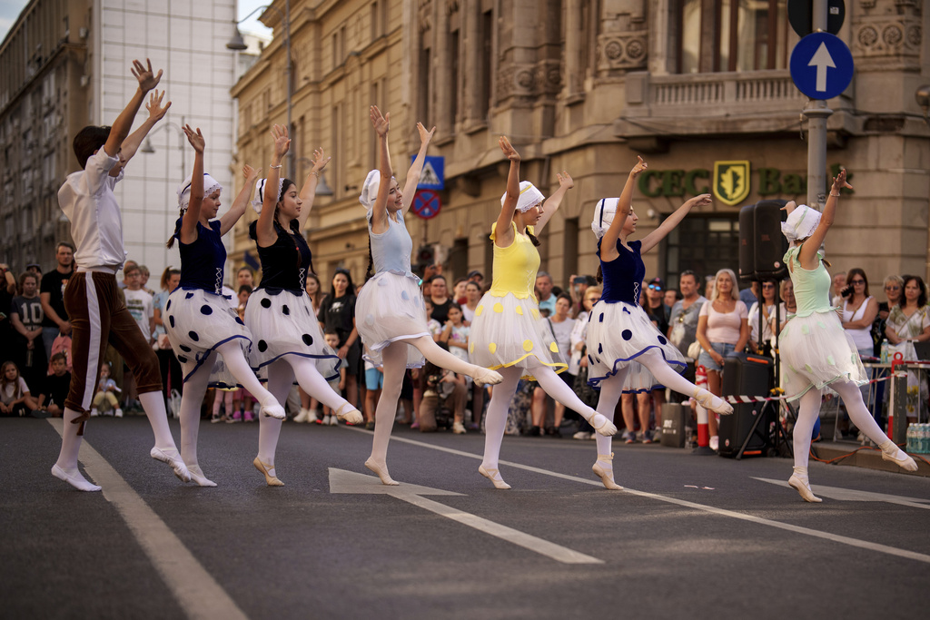 Children of the Romanian National Opera's Ballet Studio dance outside the National History Museum of Romania during Dance Night, an event featuring a wide variety of dance styles performed on the Calea Victoriei avenue in Bucharest, Romania, Saturday, Aug. 23, 2025. (AP Photo/Andreea Alexandru)