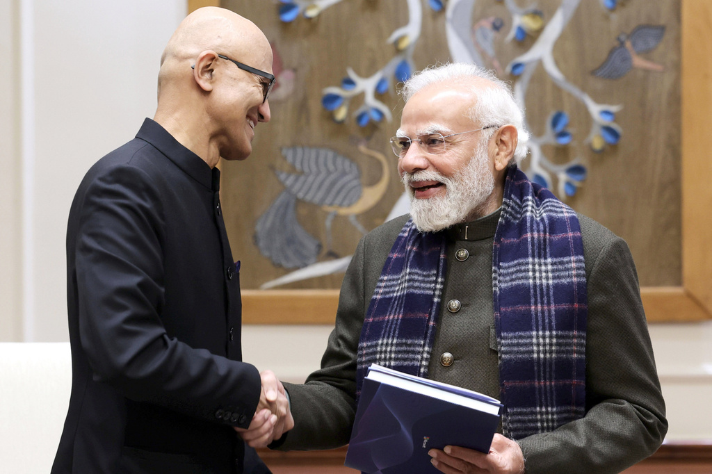 In this handout photo provided by Microsoft, Chief Executive Officer Satya Nadella, left, shakes hands with Indian Prime Minister Narendra Modi during their meeting in New Delhi, India, Tuesday, Dec. 9, 2025. (Microsoft via AP)