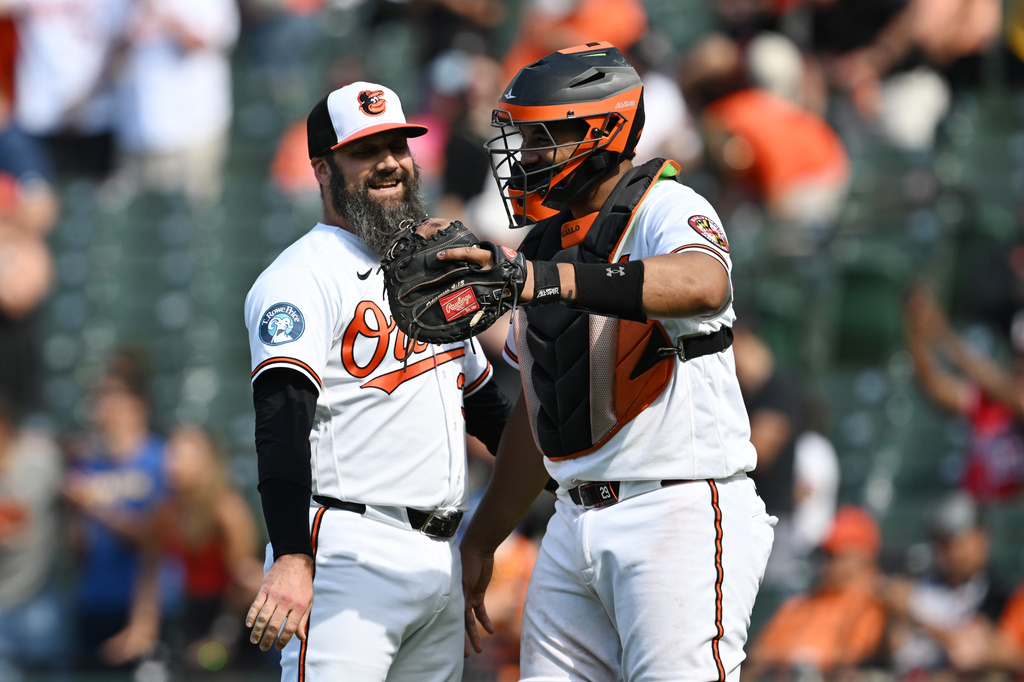 Baltimore Orioles catcher Samuel Basallo, right, and pitcher Andrew Kittredge, left, celebrate after a baseball game against the Kansas City Royals, Sunday, July 12, 2026, in Baltimore. (AP Photo/Gail Burton)