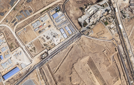 This satellite photo from Planet Labs PBC shows trucks lined up on the Egyptian side of the Rafah border crossing with the Gaza Strip on Thursday, Oct. 16, 2025. (Planet Labs PBC via AP) This satellite photo from Planet Labs PBC shows trucks lined up on the Egyptian side of the Rafah border crossing with the Gaza Strip on Thursday, Oct. 16, 2025. (Planet Labs PBC via AP)