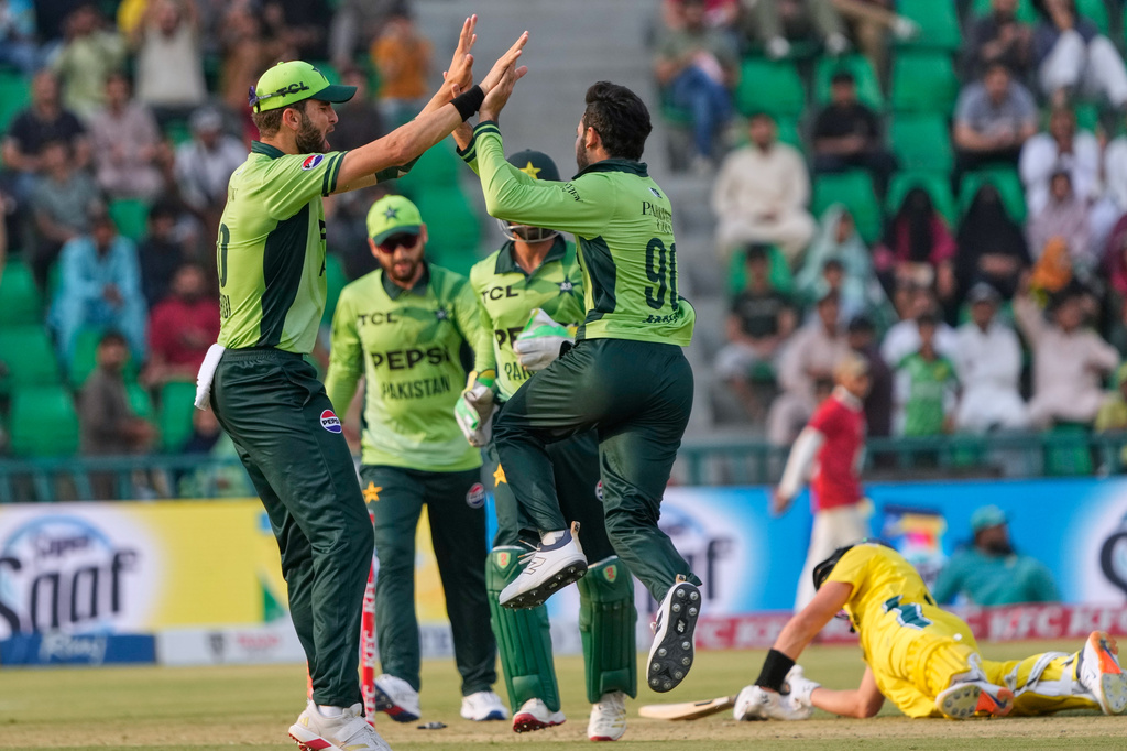 Pakistan's Arafat Minhas, centre, celebrates with teammates after the dismissal of Australia's Marnus Labuschagne, right, during the third one-day international cricket match between Pakistan and Australia, in Lahore, Pakistan, Thursday, June 4, 2026. (AP Photo/K.M. Chaudary)