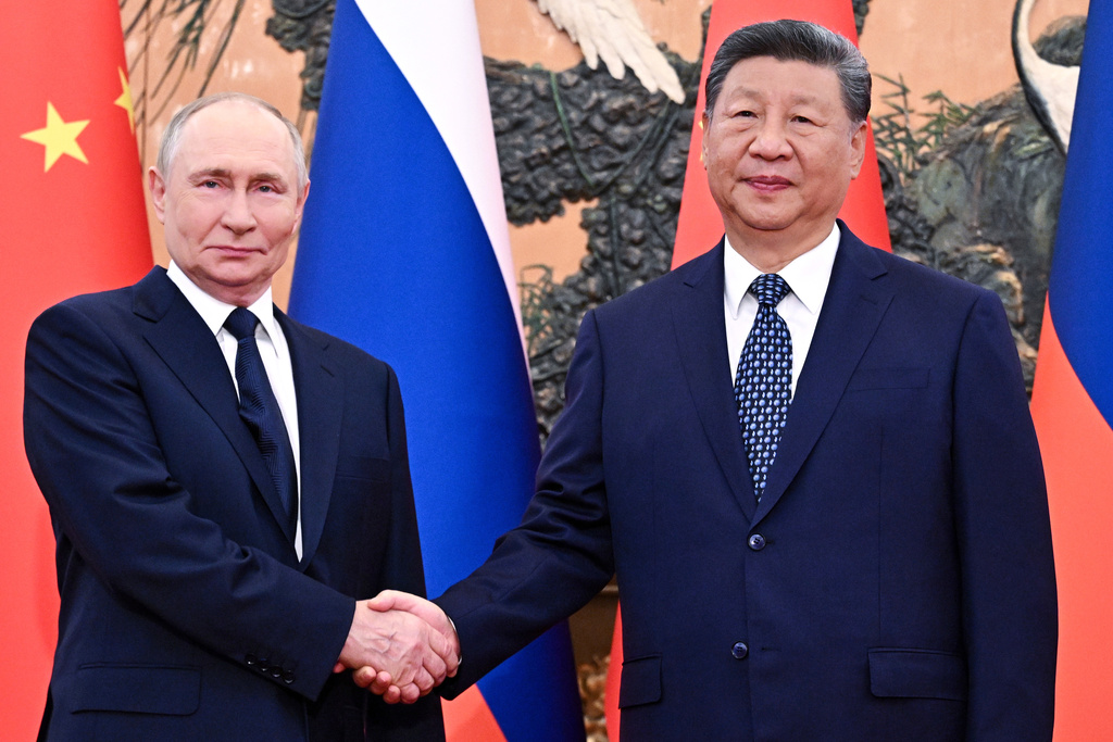 Russian President Vladimir Putin, left, and Chinese President Xi Jinping shake hands ahead of their meeting at The Great Hall of the People in Beijing, China, Tuesday, Sept. 2, 2025. (Sergei Bobylev, Sputnik, Kremlin Pool Photo via AP)