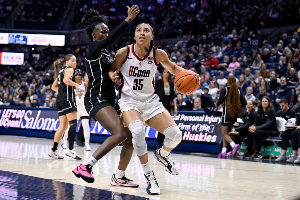 UConn guard Azzi Fudd (35) is guarded by Providence guard Sabou Gueye in the first half of an NCAA college basketball game, Sunday, Feb. 22, 2026, in Storrs, Conn. (AP Photo/Jessica Hill)