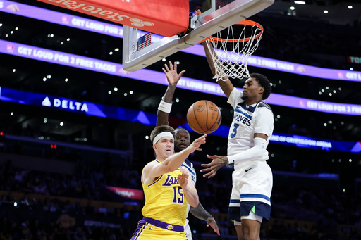 Los Angeles Lakers guard Austin Reaves (15) passes the ball against Minnesota Timberwolves forwards Julius Randle, back left, and Jaden McDaniels (3) during the first half of an NBA basketball game, Friday, Oct. 24, 2025, in Los Angeles. (AP Photo/Jessie Alcheh) Los Angeles Lakers guard Austin Reaves (15) passes the ball against Minnesota Timberwolves forwards Julius Randle, back left, and Jaden McDaniels (3) during the first half of an NBA basketball game, Friday, Oct. 24, 2025, in Los Angeles. (AP Photo/Jessie Alcheh)